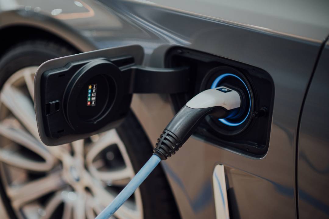 Electric Car Charger Plugged Into A Car
