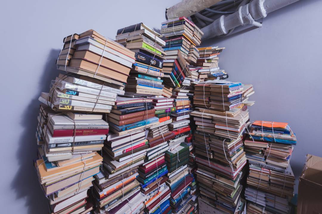 Several stacks of books piled high next to each other