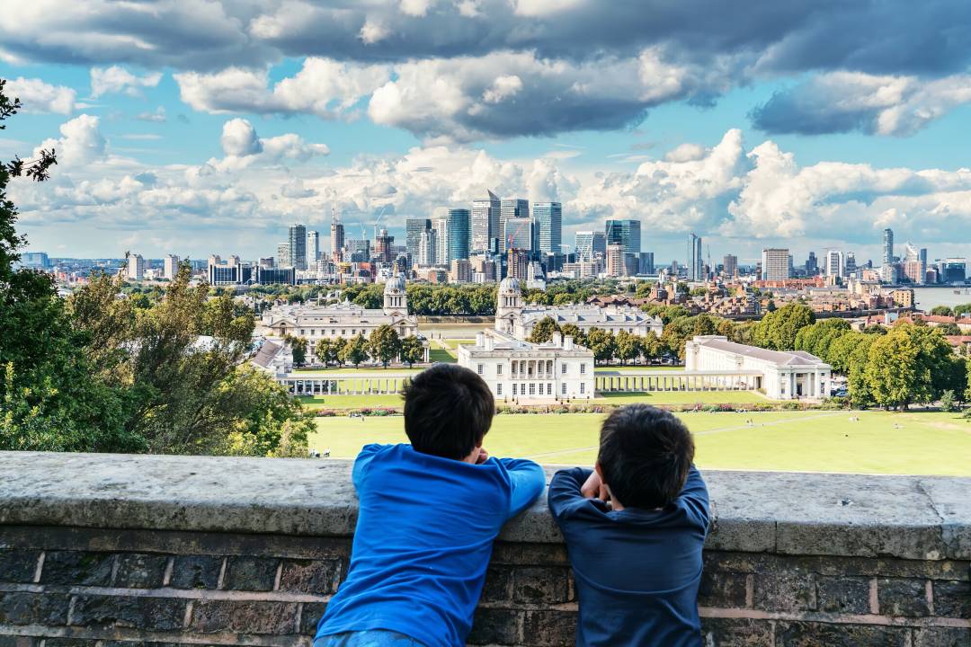 Children Leaning On Wall Looking At London Skyline