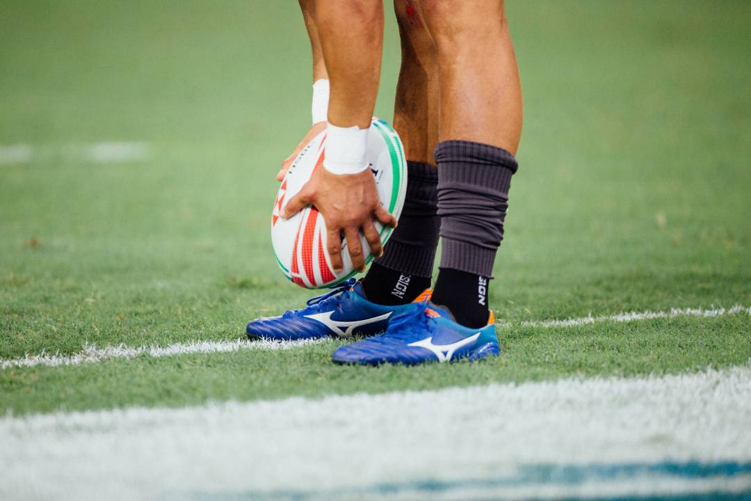 Rugby player placing a rugby ball on the pitch