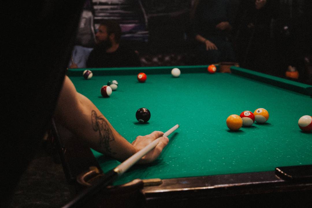 Person Playing Pool