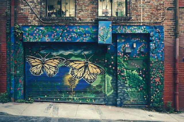 Graffiti Butterflies On A Blue Roller Shutter