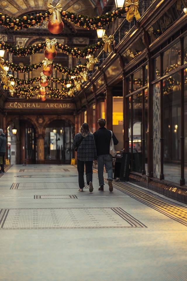 Two people walking inside the Central Arcade in Newcastle