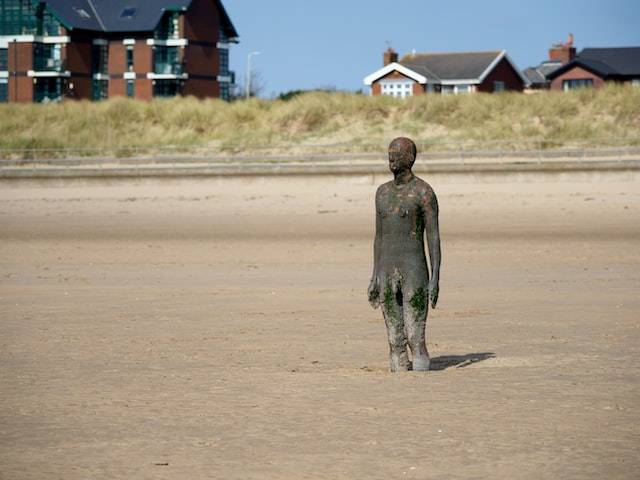 Cast-iron figure of a man on Crosby beach near Liverpool