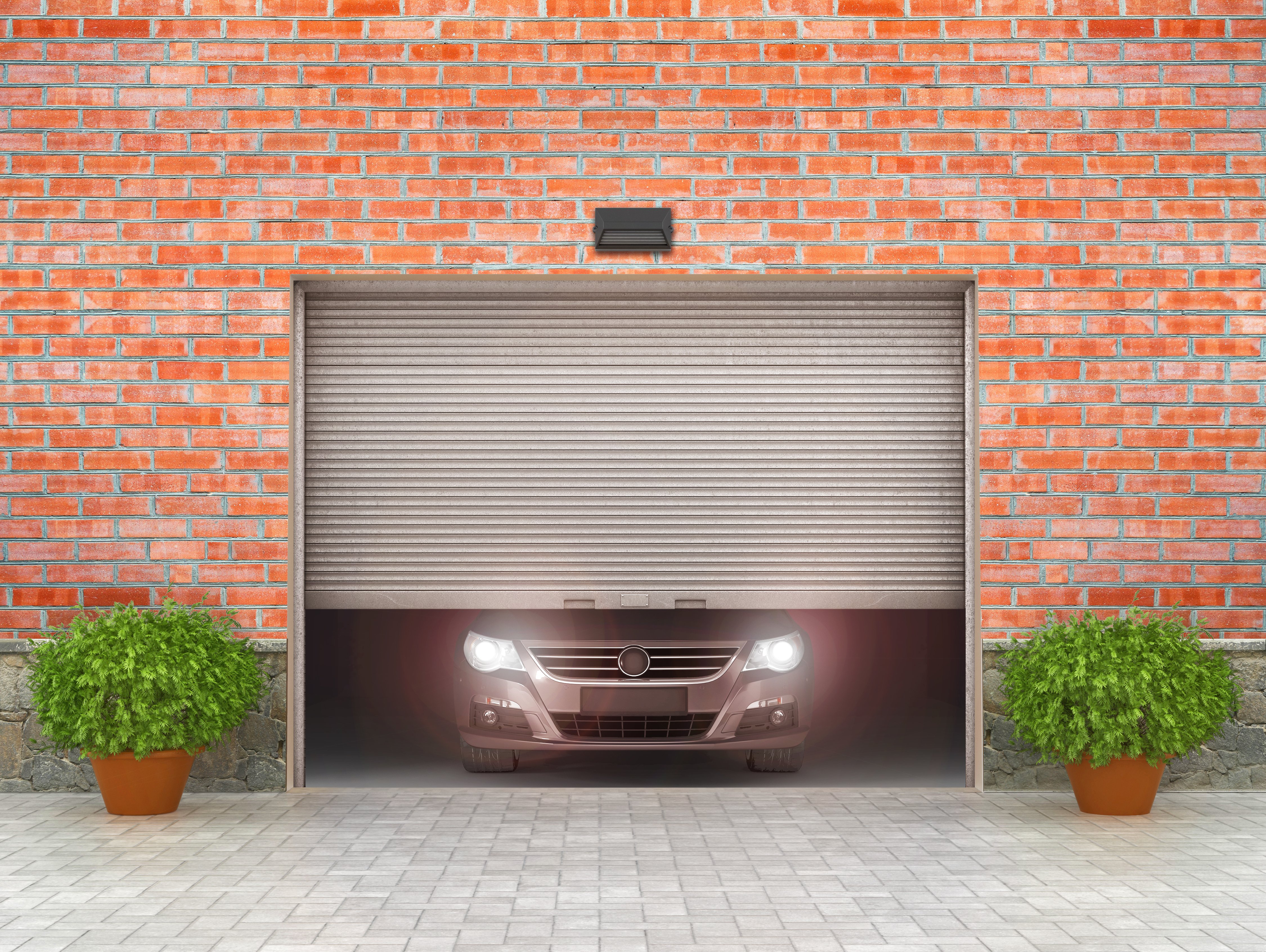 Garage door opening with a car behind it